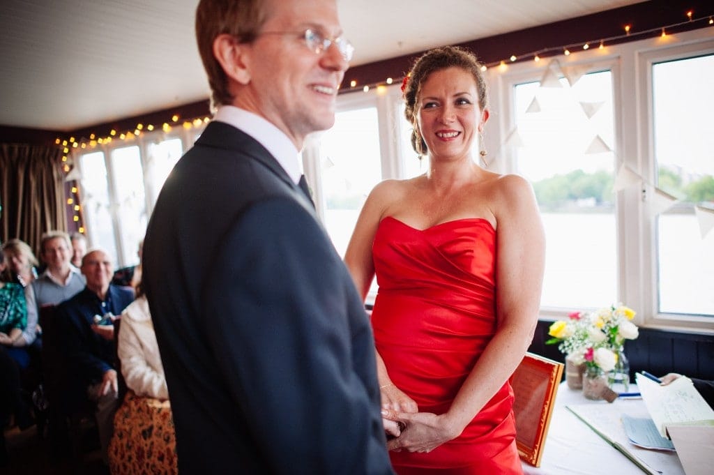 bride in red dress looking at groom