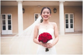 Bride holding red roses